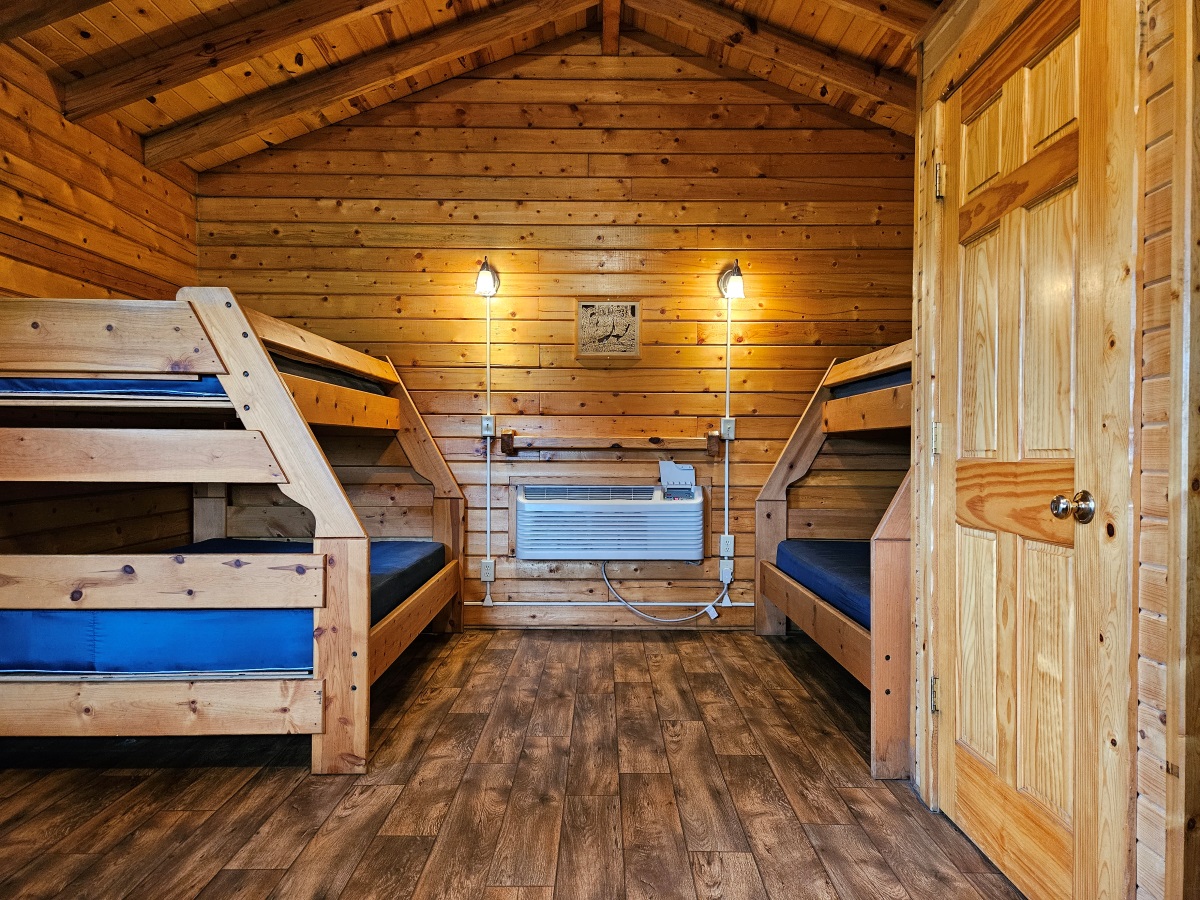 Prairie Rose - Cabin interior with two twin-over-full wooden bunk beds