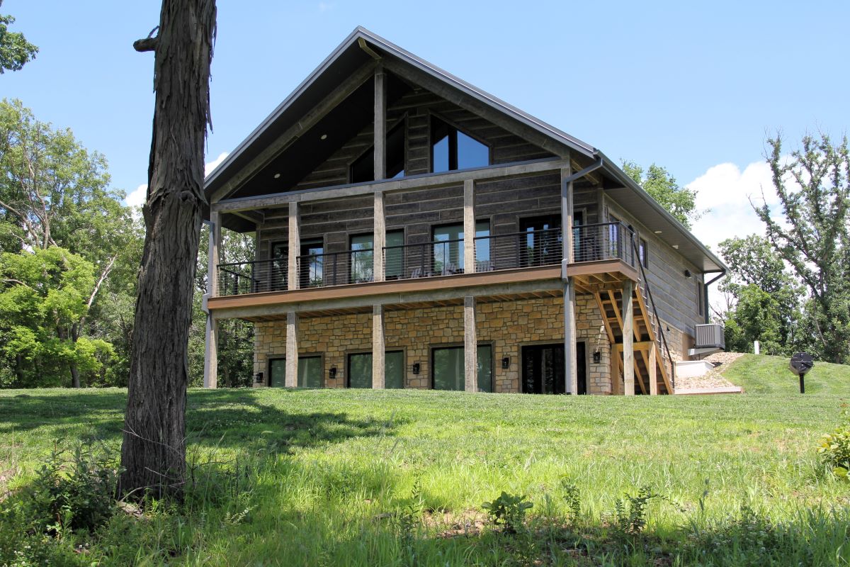Modern style rental cabin with green lawn and patios with patio furniture