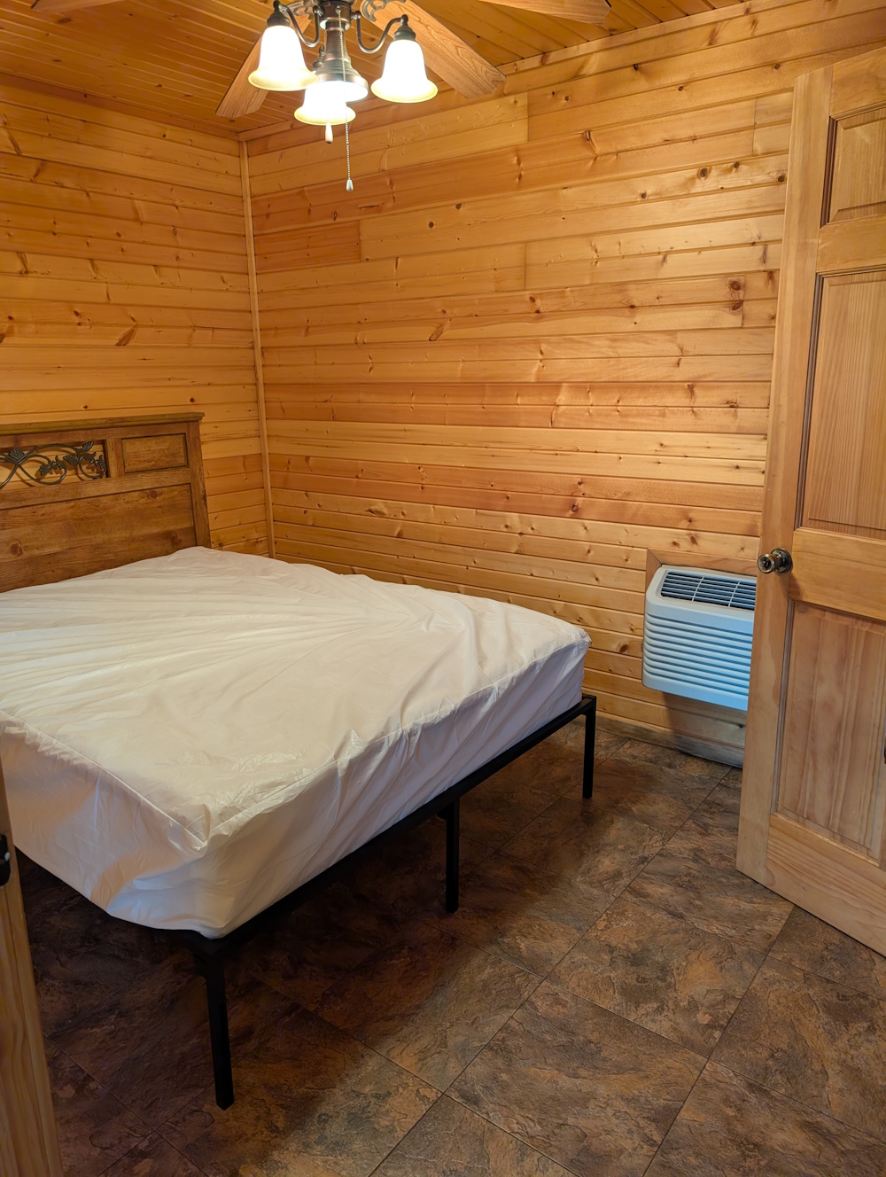 Foxes Den- private bedroom with queen bed and heat/ac unit.