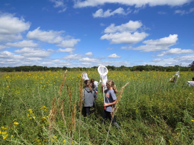 Kids with nets in prairie