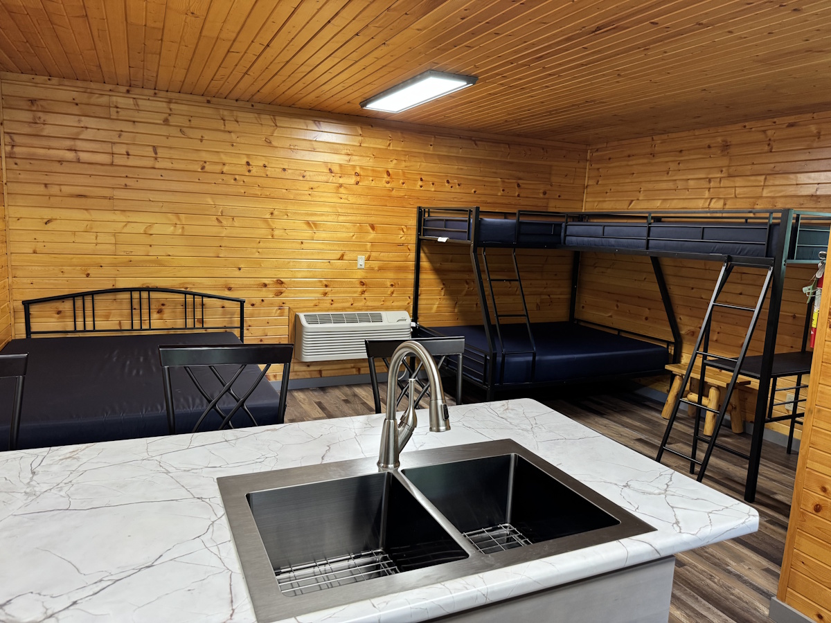 South East Corner: Looking from kitchen sink to south east corner of cabins. Bunk beds.
