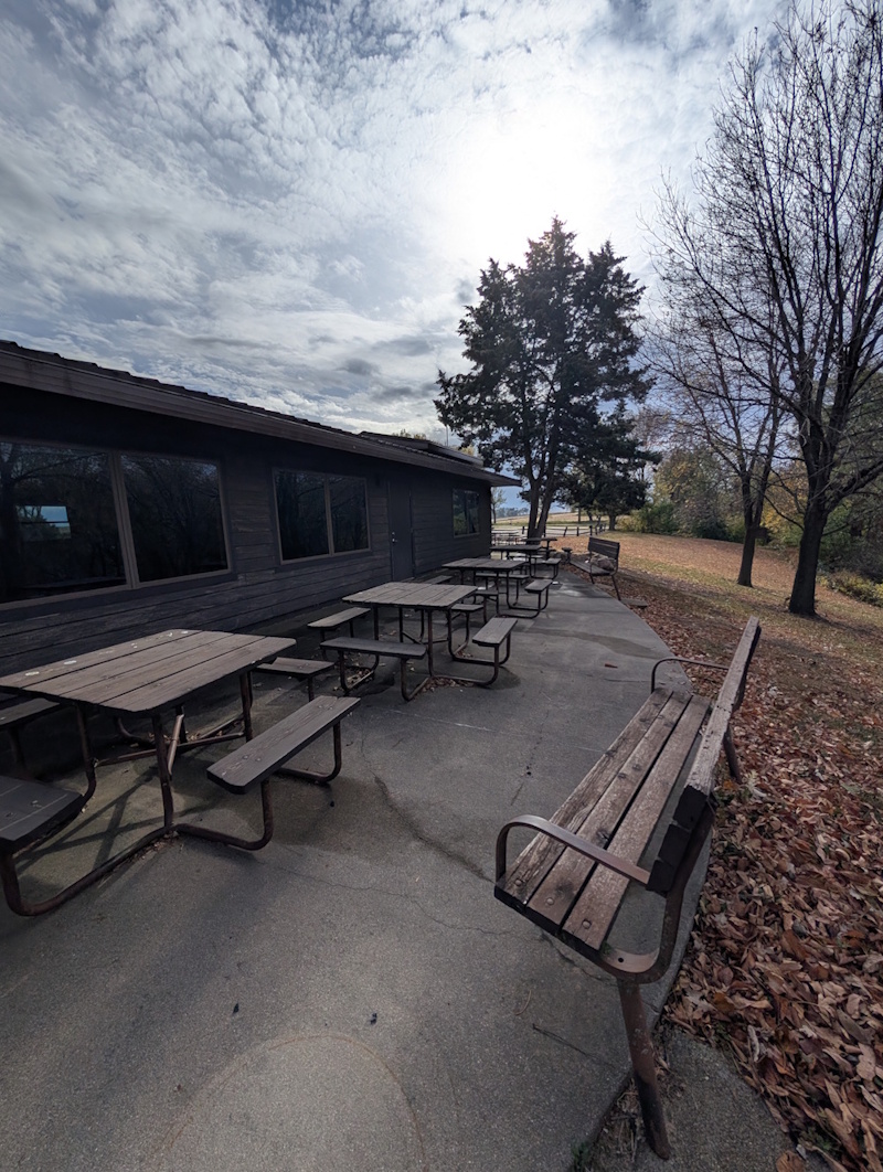 Oak Grove Lodge back patio area with square picnic tables and grill. 