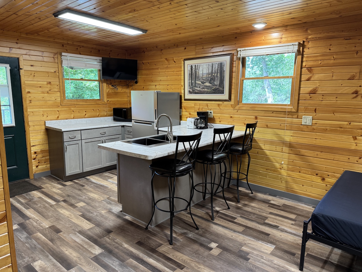 North West Corner: kitchen located in northwest conrer of cabing, bar seating on back side.