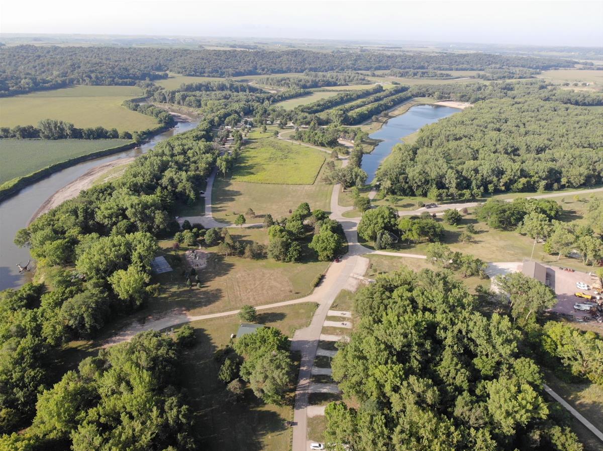 Aerial view of Little Sioux Park with campsites among trees, bordered by a river and a lake.