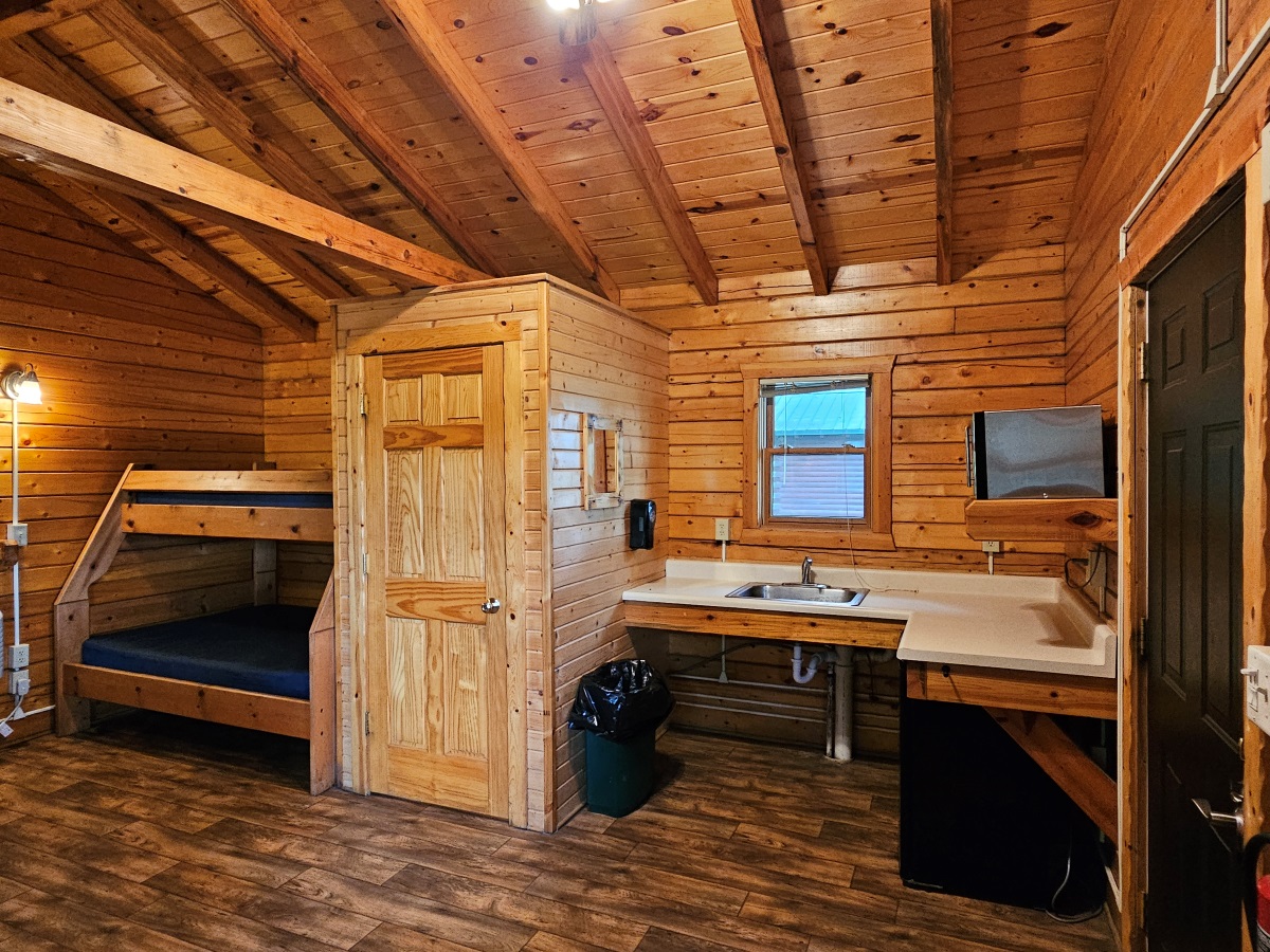 Prairie Rose - Cabin interior showing bunk bed, toilet room & kitchen area