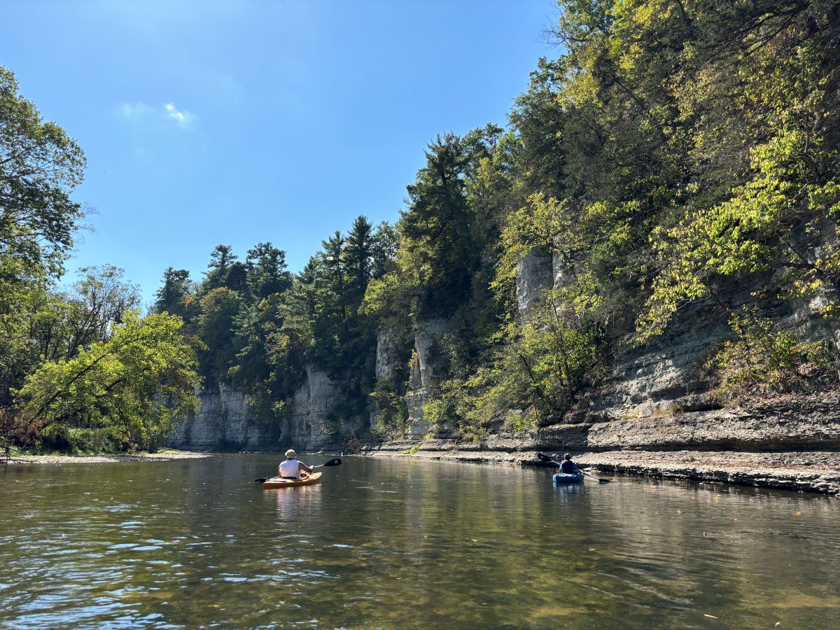 Kayakers on the Upper Iowa River past the Bluffton Bluffs