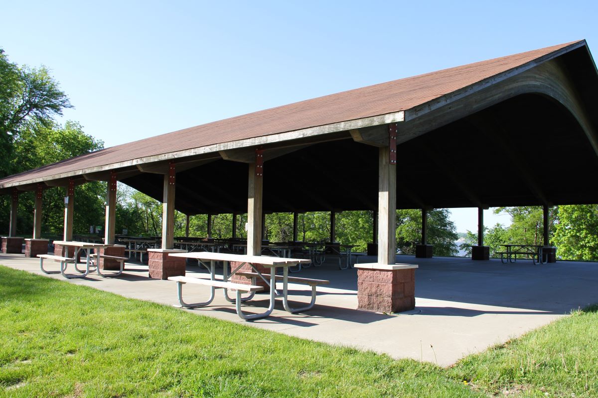 Side view in large open shower overlooking the lake in the background with picnic tables