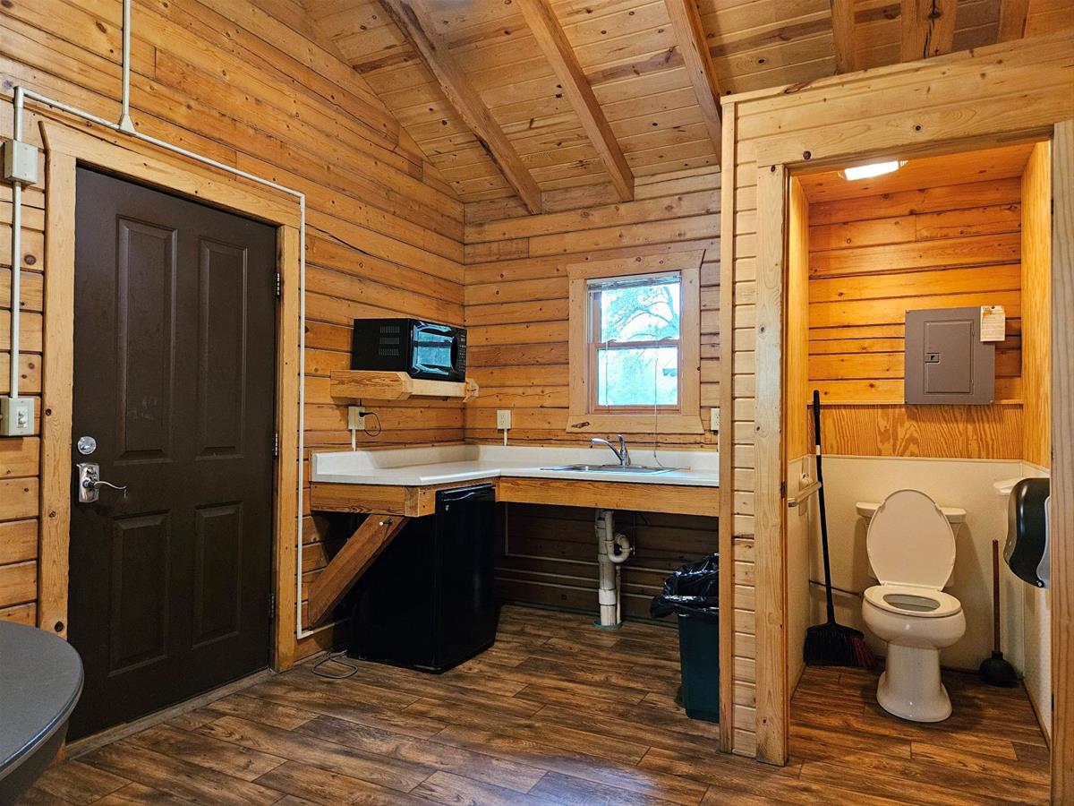 Whitetail - Cabin interior showing enclosed private toilet, kitchen area & exterior door