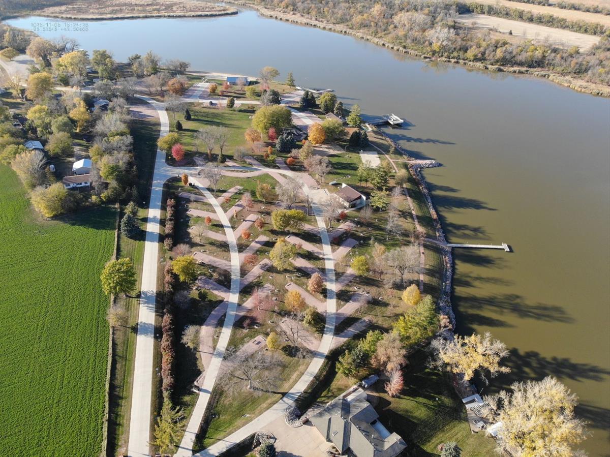Aerial view of Bigelow Park showing campsites among trees next to the lake.