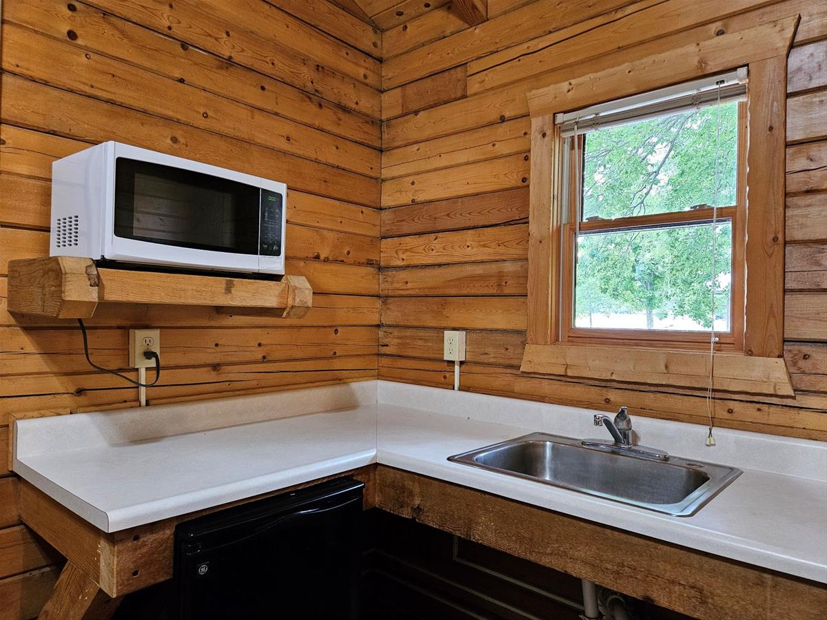 Bluestem - Cabin interior showing kitchen area with sink, microwave & mini-fridge