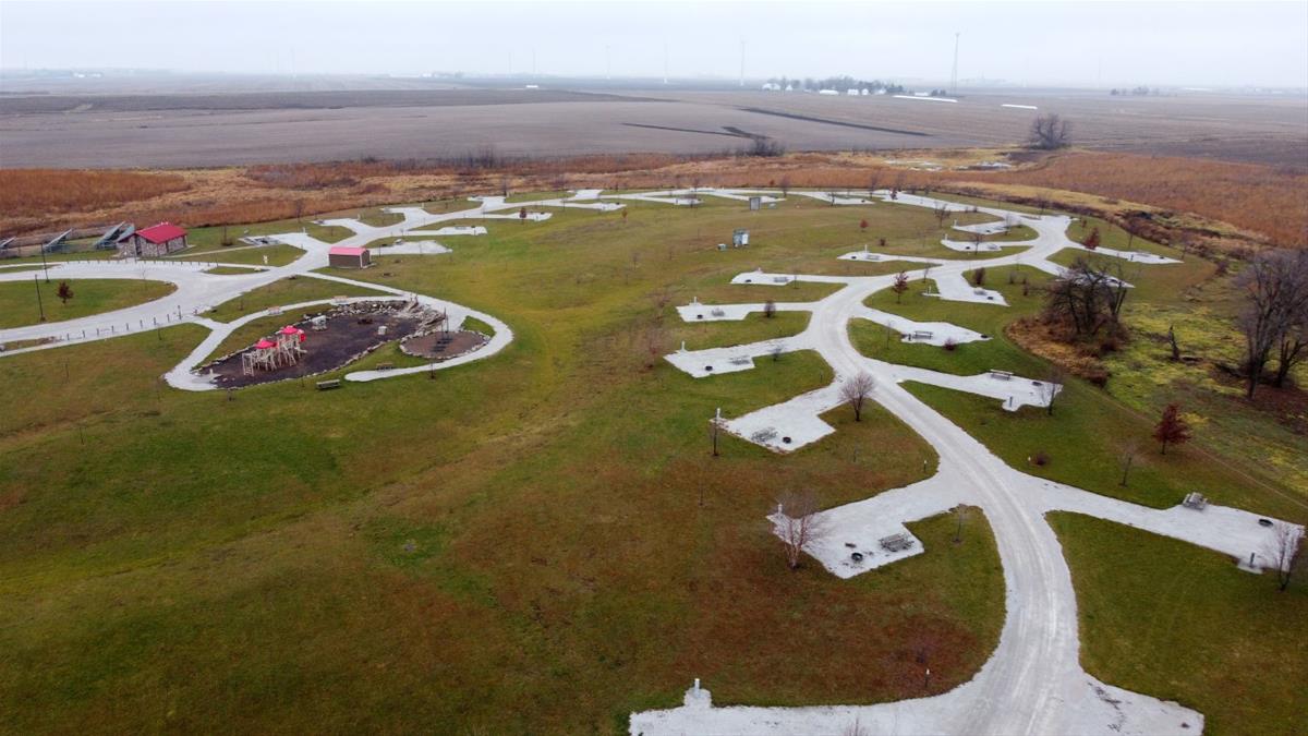 Aerial view of Dakins Main campground layout with empty campsites, playground, and shower house.